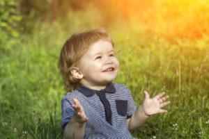 autism-resources-happy-boy-sitting-on-grass