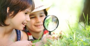 autism-resources-happy-children-exploring-nature-with-magnifying-glass