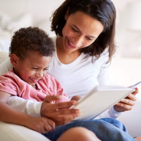 Close up of mixed race young adult mother sitting in an armchair